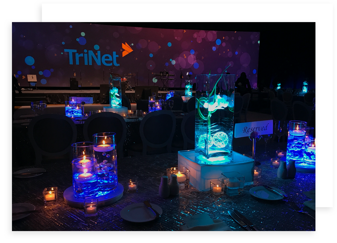 Table tops with lit up colorful vases